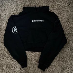 “I am unwell” cropped hoodie in black from Call Her Daddy by Barstool Sports
